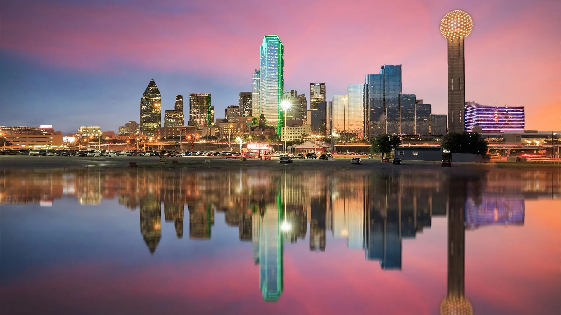 The Dallas skyline at dusk reflected in still water